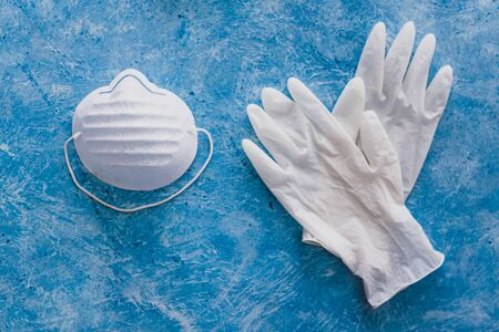 personal hygiene to flatten the curve against virus outbreaks like covid-19, disposable gloves with face mask and hand sanitizer as essential items for health safetyの写真素材