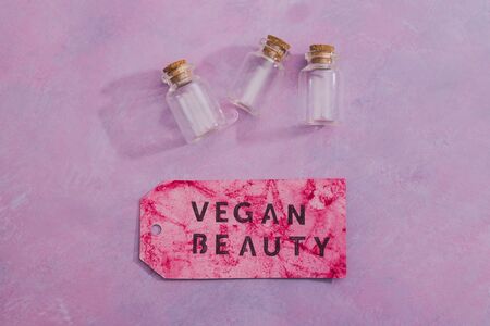 cruelty-free beauty products with no animal testing concept, group of essential oil bottles with Vegan Beauty message on label next to themの写真素材