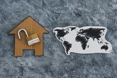 reopening businesses and restaurants after the covid-19 virus pandemic outbreak, open lock with Reopening text on it next to house icon and world mapの写真素材