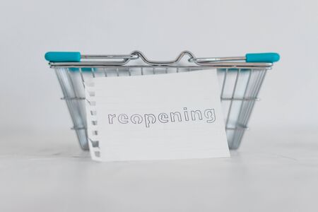 reopening businesses after the covid-19 virus pandemic, empty shopping basket with Reopning memo in...