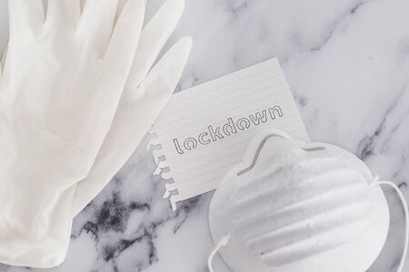 life after the global pandemic of covid-19, lockdown sign next to mask and glovesの写真素材