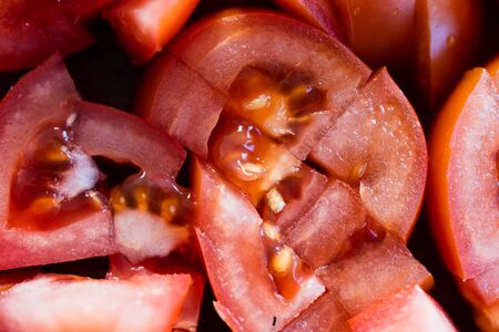 healthy plant-based food, close-up shot of chopped tomatoes on cutting boardsの写真素材