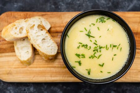 healthy plant-based food recipes concept, vegan corn cauliflower soup with chives topping and bread slices の写真素材