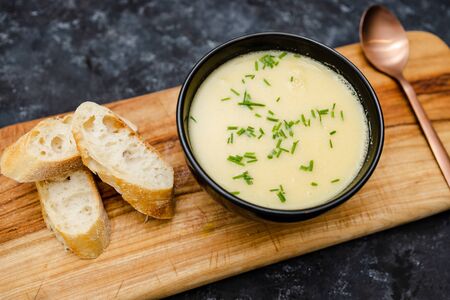 healthy plant-based food recipes concept, vegan corn cauliflower soup with chives topping and bread slices の写真素材