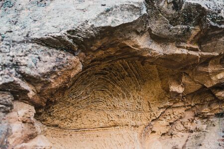 curved rock cave along the shores in the Tasmania, Australiaの写真素材