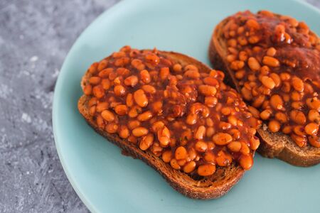 healthy plant-based food recipes concept, baked beans on rye bread toastの写真素材