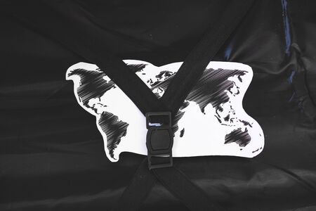travel and aviation industry concept, open carry-on luggage with world map inside of it