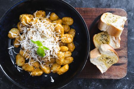 healthy plant-based food recipes concept, vegan red pesto gnocchi with dairy-free cheese topping