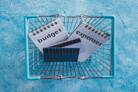 managing money and finance concept, budget and expenses notepads side by side on blue desk with...