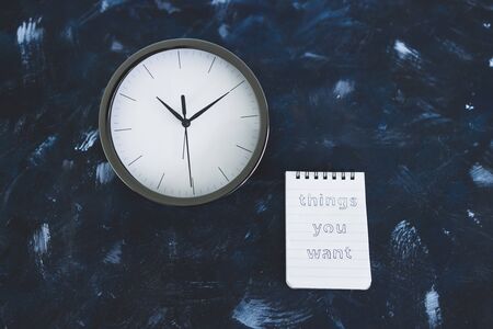meditation and psychology concept, notepad with title Things you want on desk next to clock metaphor...