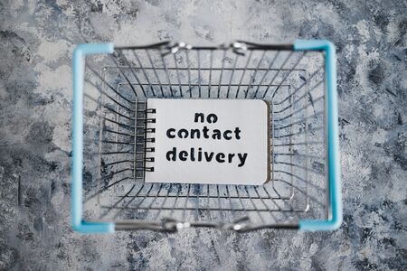 the new normal after covid-19, No Contact Delivery text on notepad inside shopping basket symbol of...