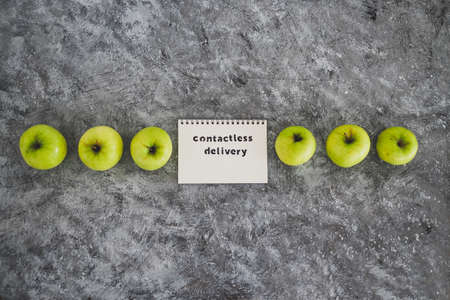 the new normal after covid-19, Contactless Delivery text on notepad among apples concept of...