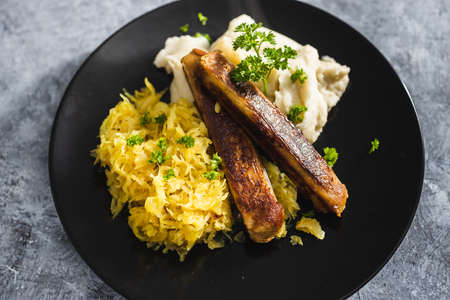 healthy plant-based food recipes concept, vegan sausages with sauerkraut and mash potatoesの写真素材