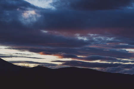 sunset sky with beautiful clouds rolling over the hills of Tasmania, Australiaの写真素材