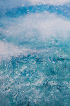 white and blue abstract painting reminiscence of ocean texture with waves or starry night with clouds made with acrylic paint on woodの写真素材