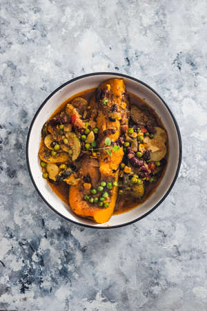 healthy plant-based food recipes concept, vegan butternut squash roast with beans and mixed mediterrnean vegetables in spicy brothの写真素材