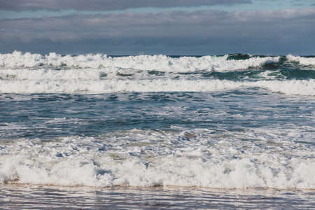 strong waves and pristine untouched Australian beach in Marion Bay in Tasmania with no people on a beautiful winter dayの写真素材