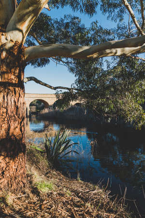 RICHMOND, July 17th, 2020: the Richmond Bridge in Tasmania on a sunny winter day with people enjoying visitng the historical setting with its heritage listed arch bridgeのeditorial素材