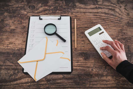 business life concept, desk with mixed business objects including to do list letters and hand typing...