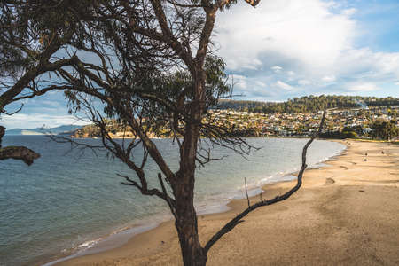HOBART, TASMANIA - August 1stt, 2020: Blackmans Bay beach on a sunny winter day with few people at the beach, the area is an affluent suburb in South Hobartのeditorial素材
