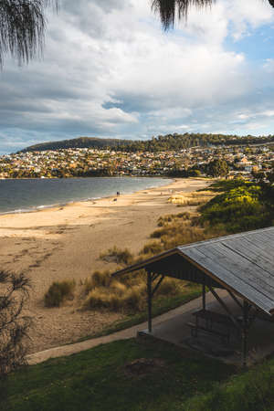 HOBART, TASMANIA - August 1stt, 2020: Blackmans Bay beach on a sunny winter day with few people at the beach, the area is an affluent suburb in South Hobartのeditorial素材