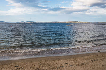 HOBART, TASMANIA - August 1stt, 2020: Blackmans Bay beach on a sunny winter day with few people at the beach, the area is an affluent suburb in South Hobartのeditorial素材