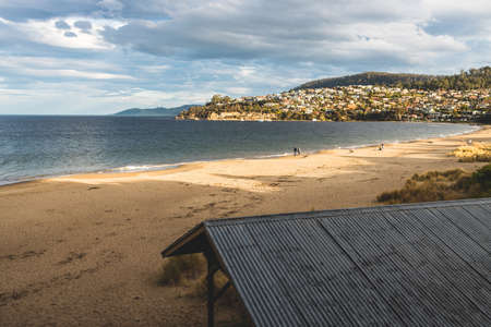 HOBART, TASMANIA - August 1stt, 2020: Blackmans Bay beach on a sunny winter day with few people at the beach, the area is an affluent suburb in South Hobartのeditorial素材