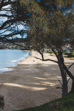 HOBART, TASMANIA - August 1stt, 2020: Blackmans Bay beach on a sunny winter day with few people at...