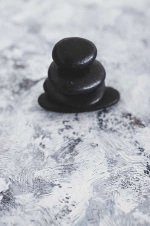 mental health concept, meditation inspired image with  stack of zen pebbles on grey concrete surfaceの写真素材
