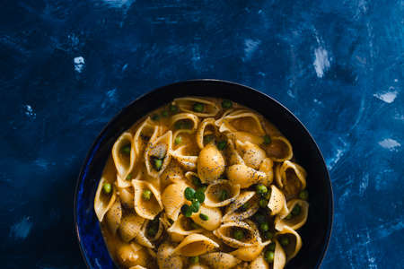 healthy plant-based food recipes concept, vegan shells pasta with pumpkin sauce and peasの写真素材