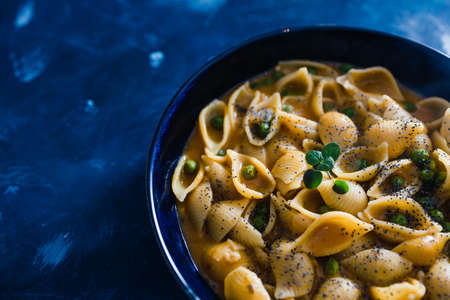 healthy plant-based food recipes concept, vegan shells pasta with pumpkin sauce and peasの写真素材