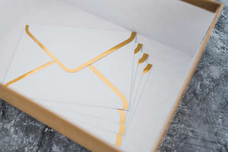 concept of inbox organisation and clean-up, group of envelopes inside box metaphor of email inboxの写真素材