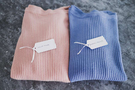 shopping and marketing concept, knit jumpers in alternative colours with Must Have and Fashion Trends text on price tagの写真素材