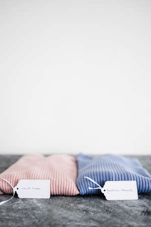 shopping and marketing concept, knit jumpers in alternative colours with Must Have and Fashion Trends text on price tagの写真素材