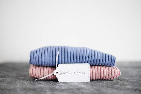 shopping and marketing concept, knit jumpers in alternative colours with Fashion Trends text on...