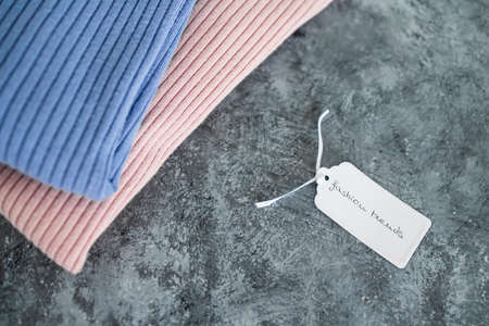 shopping and marketing concept, knit jumpers in alternative colours with Fashion Trends text on price tagの写真素材