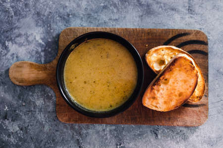 healthy plant-based food recipes concept, vegan pesto and zucchini soup with toasted breadの写真素材
