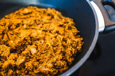 healthy plant-based food recipes concept, vegan spicy cous cous with moroccan spices and turmeric cooking in the panの写真素材