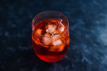 summer drinks and alcoholic beverages, refreshing red cocktail with ice on dark backgroundの写真素材