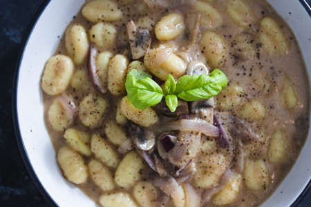 healthy plant-based food recipes concept, vegan mushroom gnocchi with dairy-free mushroom sauce ance...