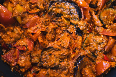 healthy plant-based food recipes concept, vegan eggplant zucchini and red pepper mix getting sauteed...