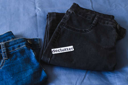 tidying up and organizing your wardrobe, Declutter label on different jeans in various denim colors