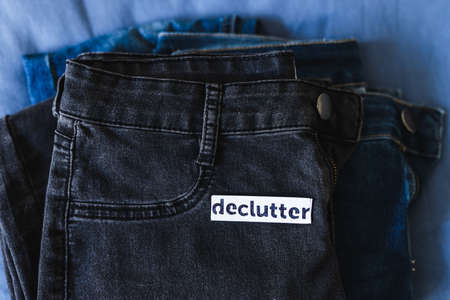 tidying up and organizing your wardrobe, Declutter label on different jeans in various denim colorsの写真素材