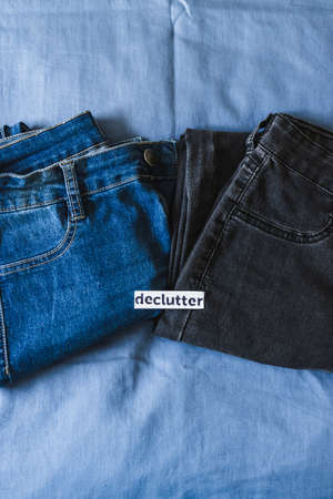 tidying up and organizing your wardrobe, Declutter label on different jeans in various denim colors