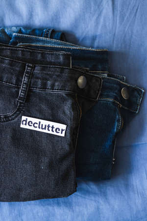 tidying up and organizing your wardrobe, Declutter label on different jeans in various denim colors