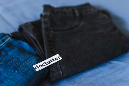 tidying up and organizing your wardrobe, Declutter label on different jeans in various denim colorsの写真素材