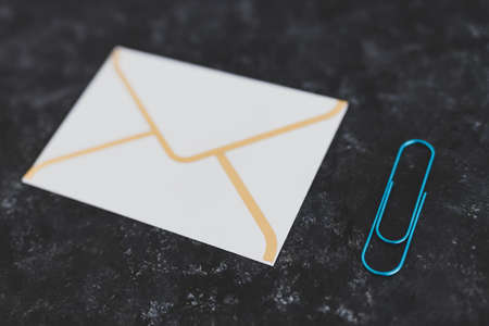 concept of email communication, email envelope icon with clip for attachmentsの写真素材
