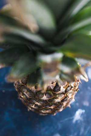 simple food ingredients concept, close-up of pineapple on dark blue backgroundの写真素材