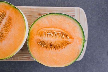 simple food ingredients concept, close-up of rockmelon on cutting boardの写真素材