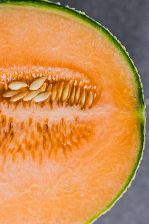 simple food ingredients concept, close-up of rockmelon on cutting boardの写真素材